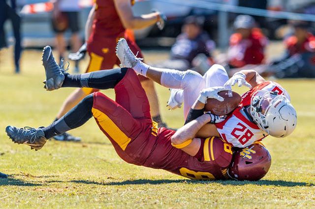 football player tackling another player